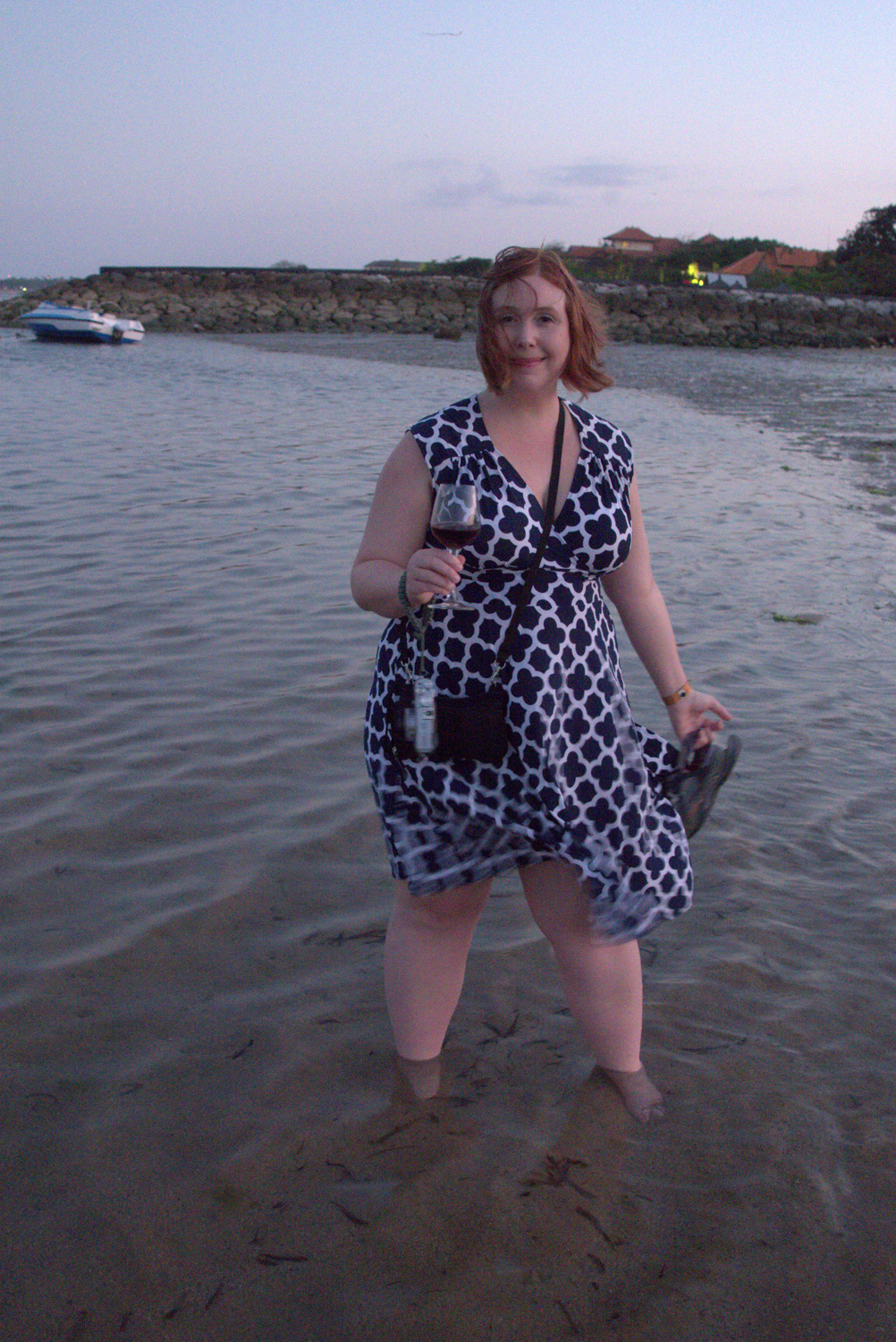 Sophie in the surf with wine